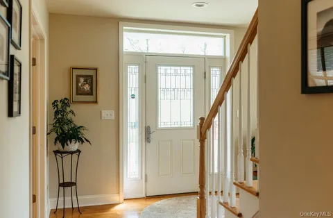 a front view of a house with wooden floor and a potted plant
