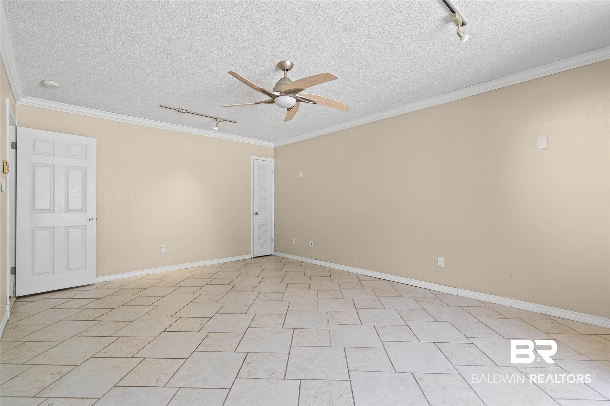 3724 Claridge Road South Mobile, AL 36608 - Photo 21 of 42 Spare room with rail lighting, a ceiling fan, a textured ceiling, and ornamental molding