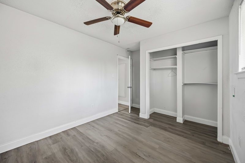 12659 Chiswick Road Houston, TX 77047 - Photo 13 of 21 an empty room with wooden floor ceiling fan and window