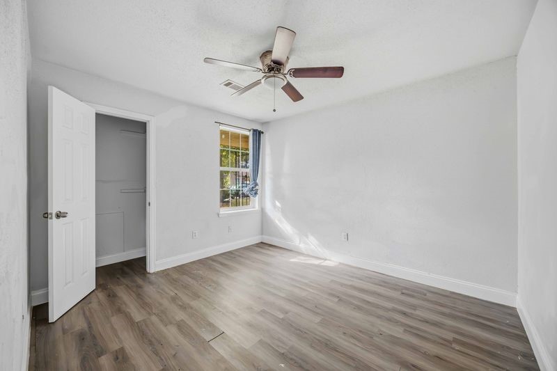 12659 Chiswick Road Houston, TX 77047 - Photo 14 of 21 wooden floor in an empty room with a window