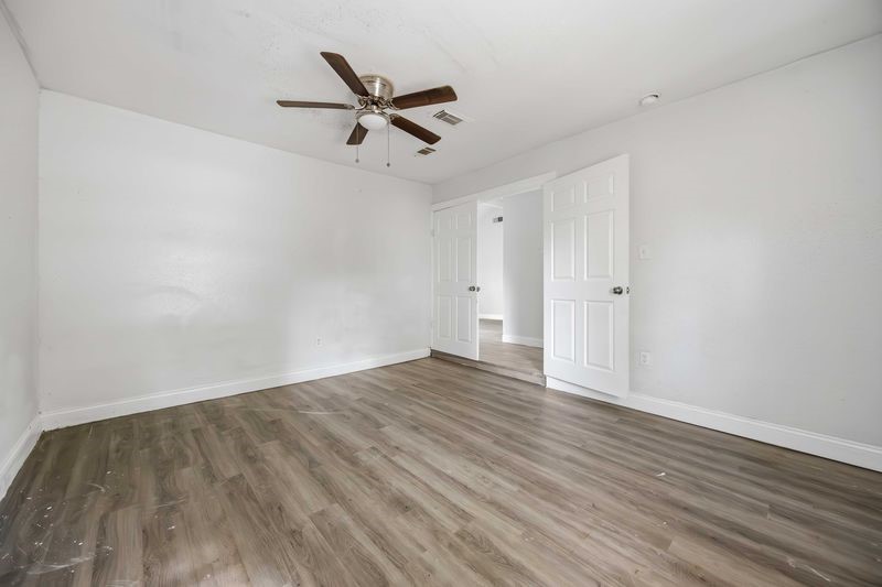 12659 Chiswick Road Houston, TX 77047 - Photo 17 of 21 a view of empty room with wooden floor and ceiling fan