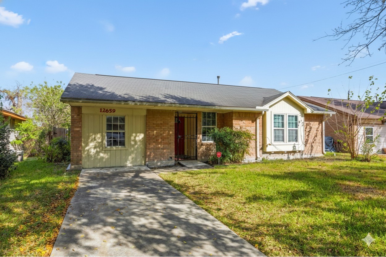 12659 Chiswick Road Houston, TX 77047 - Photo 2 of 21 a view of a house with a yard and sitting area