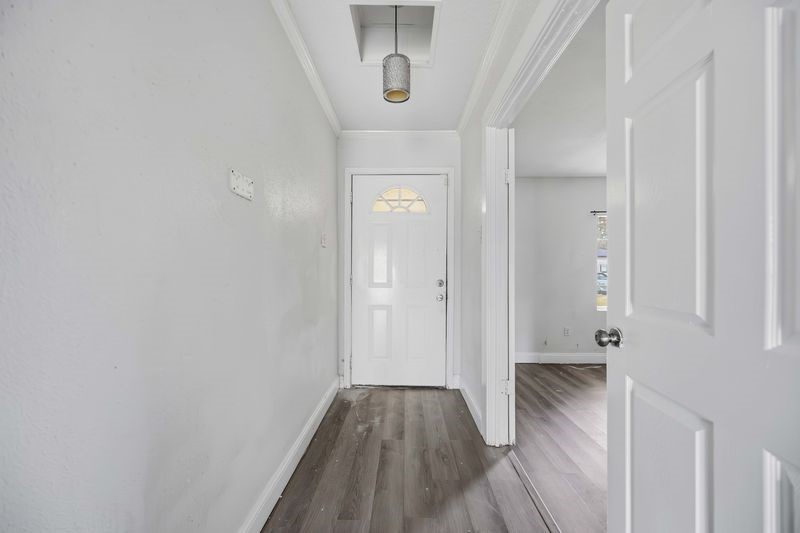 12659 Chiswick Road Houston, TX 77047 - Photo 3 of 21 a view of a hallway with wooden floor and staircase