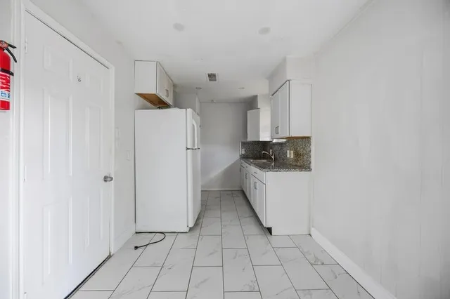 a utility room with cabinets washer and dryer