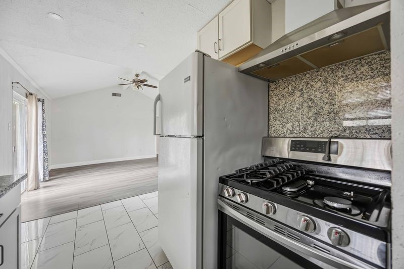 12659 Chiswick Road Houston, TX 77047 - Photo 9 of 21 a kitchen with a stove and a refrigerator