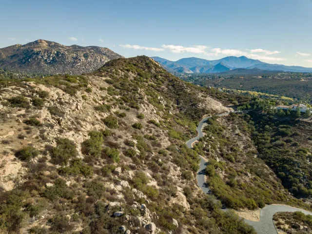 a view of a large mountain with a mountain in the background