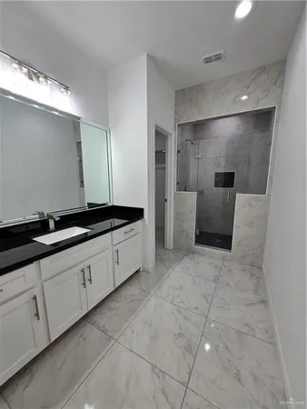 a large bathroom with a sink and a large mirror