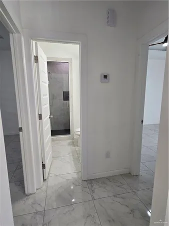 a view of a hallway to rooms