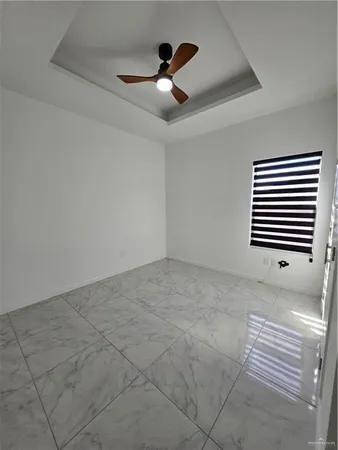 a view of an empty room with a ceiling fan