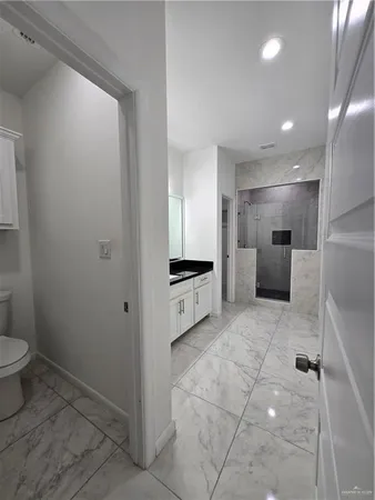 a bathroom with a toilet sink and a mirror