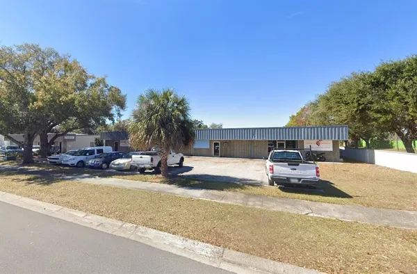 a view of a house with swimming pool and sitting area