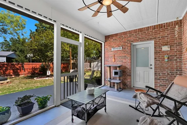 a balcony with furniture and a potted plant