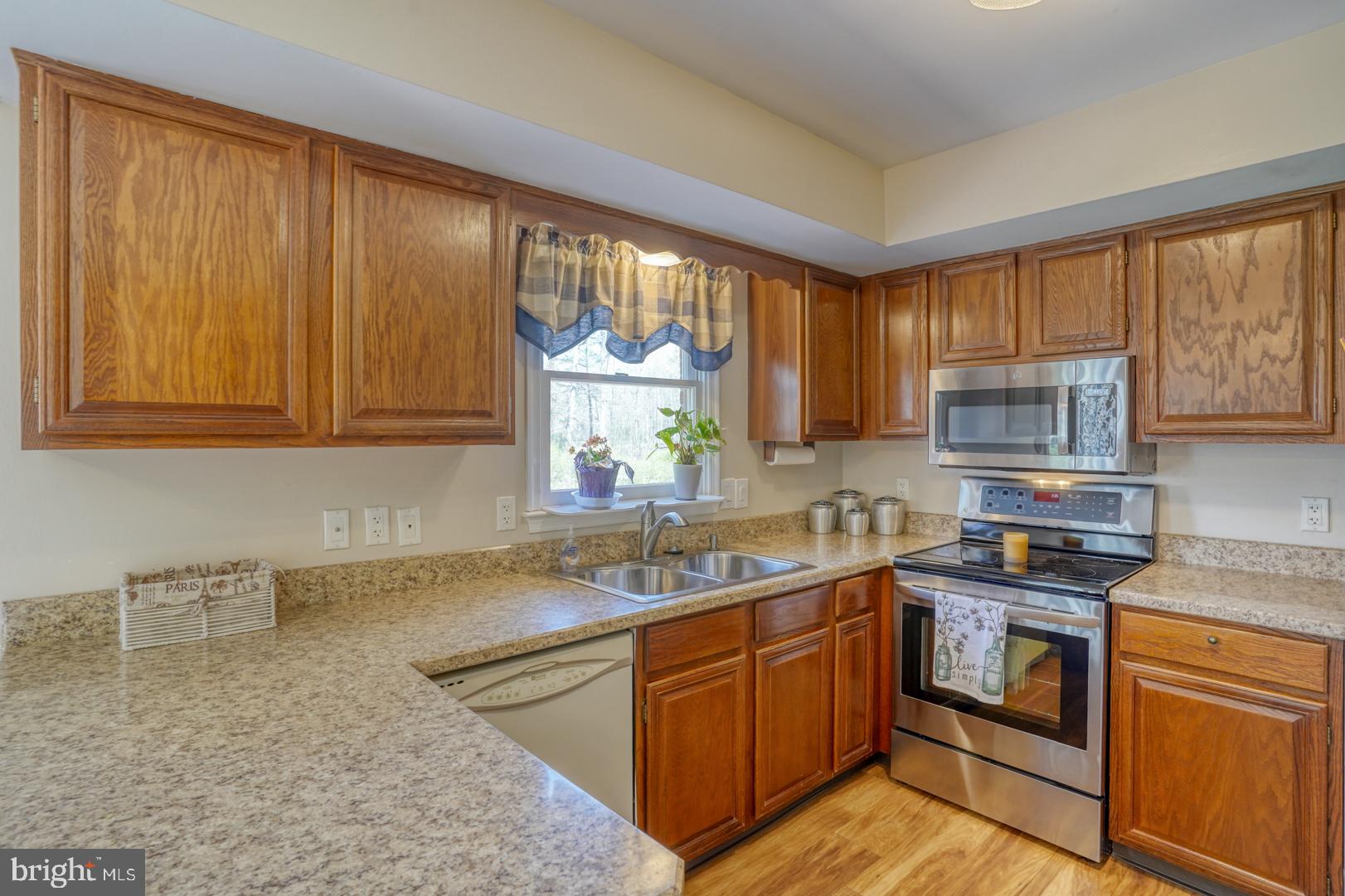 20 Tammie Drive Bear, DE 19701 - Photo 22 of 37 a kitchen with stainless steel appliances granite countertop a sink stove and cabinets