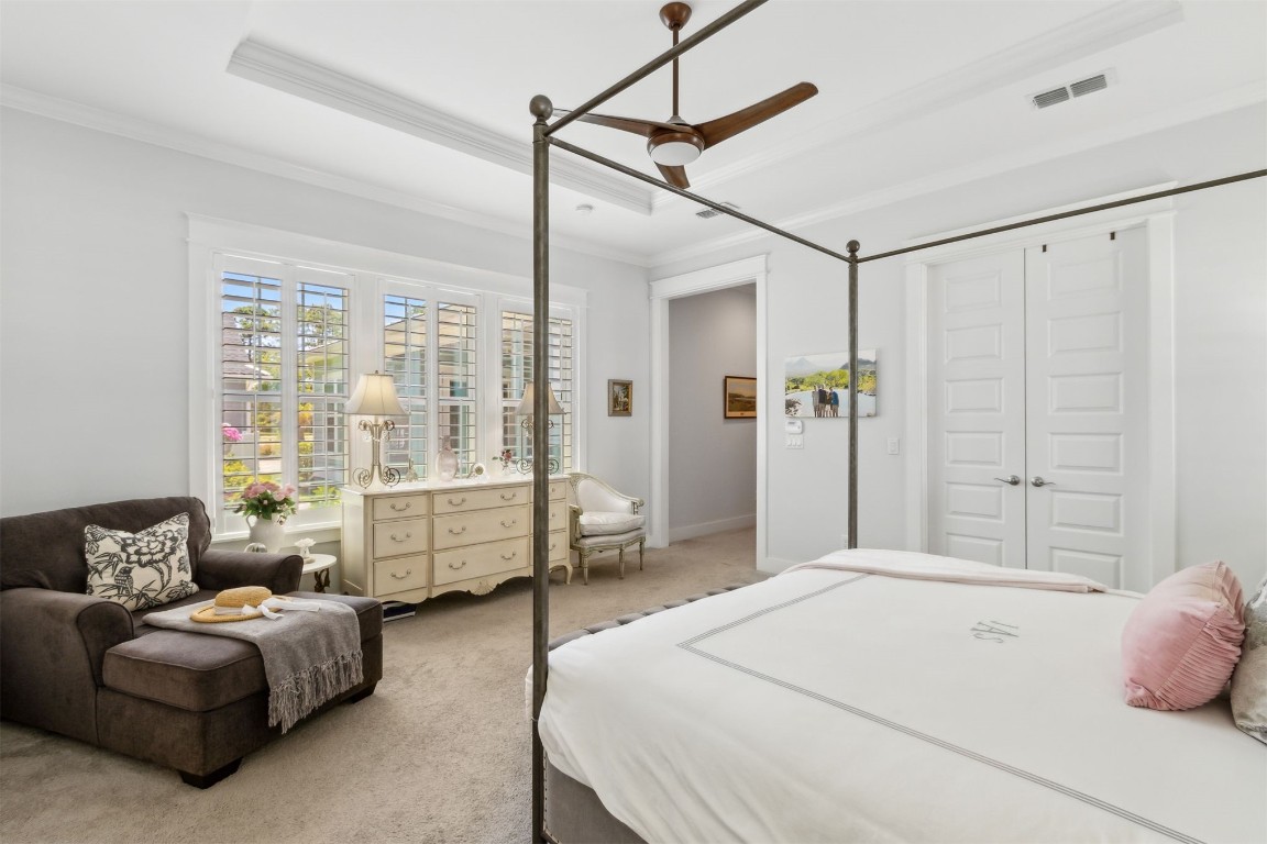 2930 Riverbend Walk Fernandina Beach, FL 32034 - Photo 21 of 60 a spacious bedroom with a bed and a chandelier