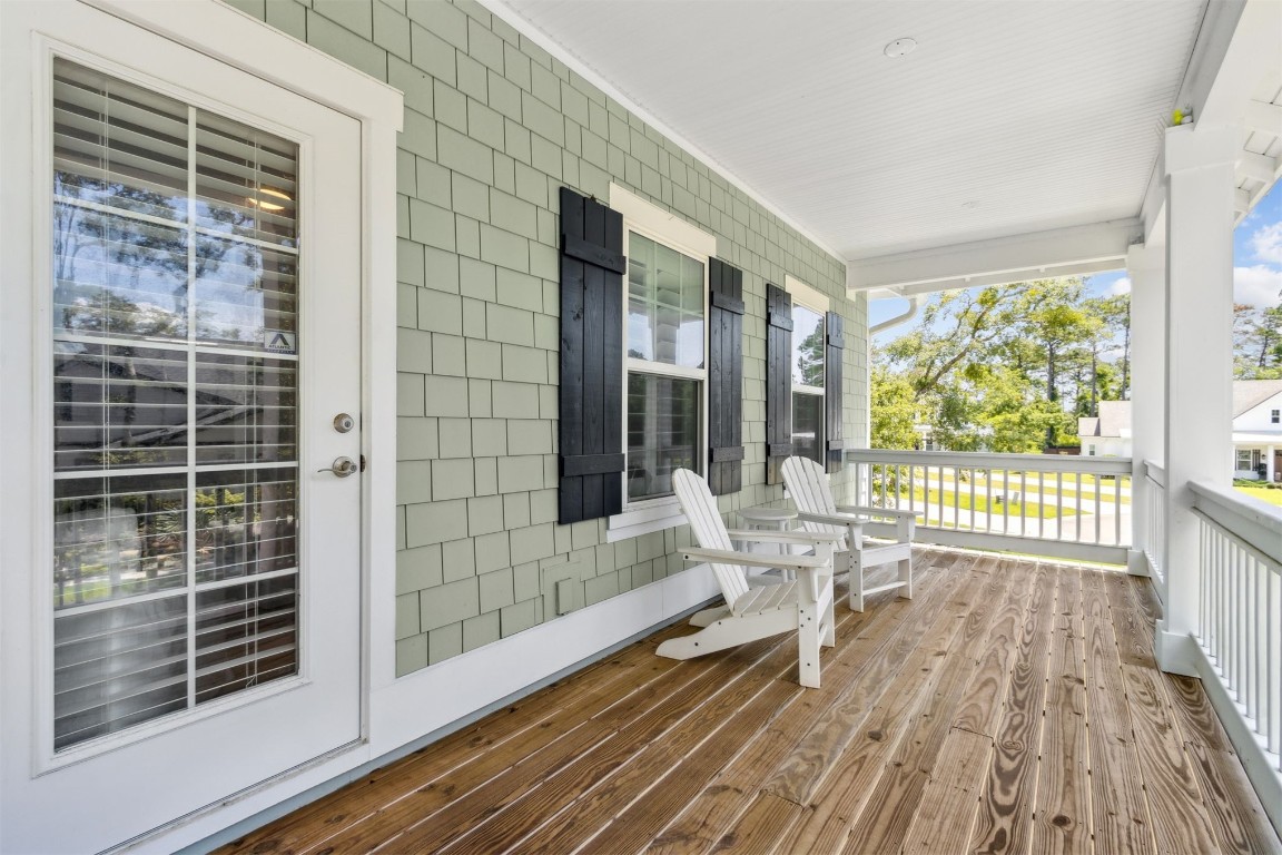 2930 Riverbend Walk Fernandina Beach, FL 32034 - Photo 40 of 60 a balcony with wooden floor and furniture