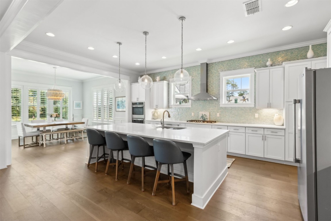 2930 Riverbend Walk Fernandina Beach, FL 32034 - Photo 8 of 60 a kitchen with stainless steel appliances kitchen island granite countertop a table chairs sink and window