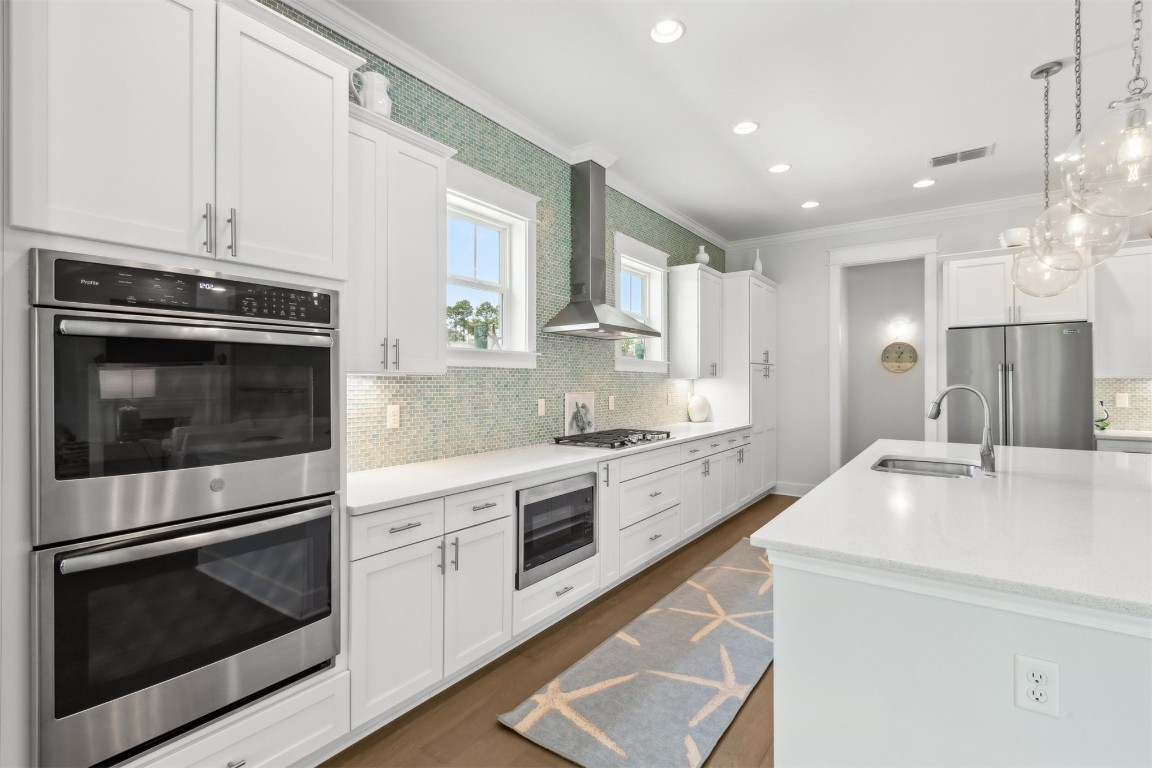 2930 Riverbend Walk Fernandina Beach, FL 32034 - Photo 10 of 60 a kitchen with stainless steel appliances white cabinets and a stove