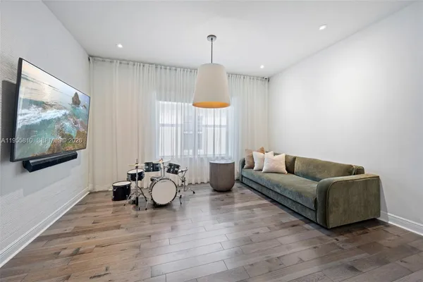 a bedroom with a bed a couch and dresser