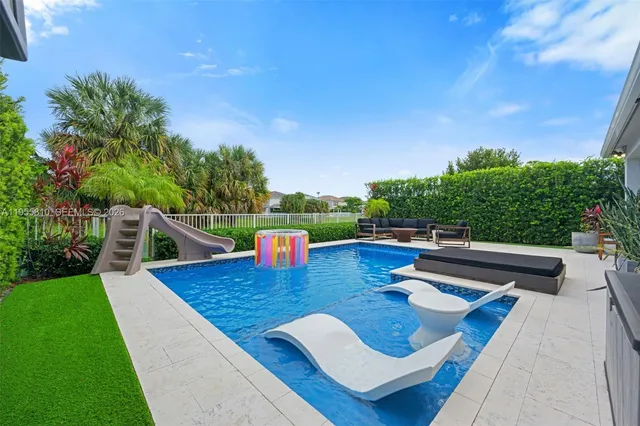 a view of outdoor sitting area with furniture and city view