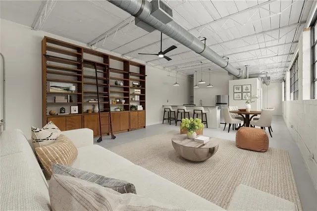 a living room with furniture a dining table and chairs