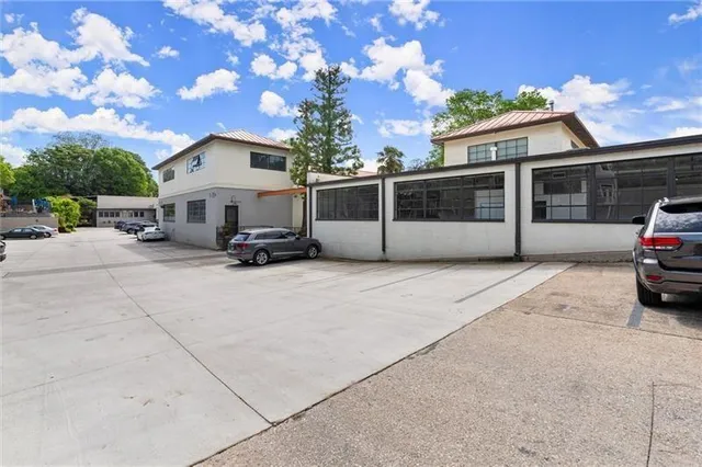 a view of a patio with couches table and chairs and potted plants