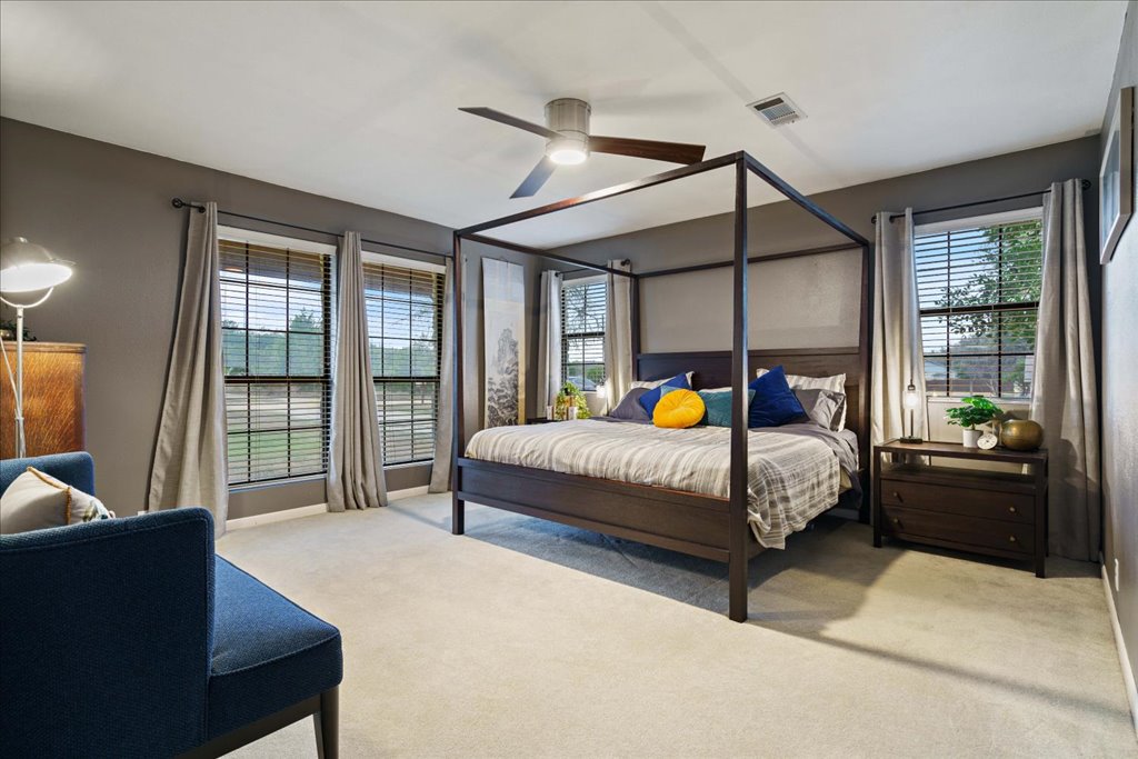 5014 Little Valley Road Leander, TX 78641 - Photo 11 of 20 A tranquil bedroom retreat features ample natural light and plush carpeting.