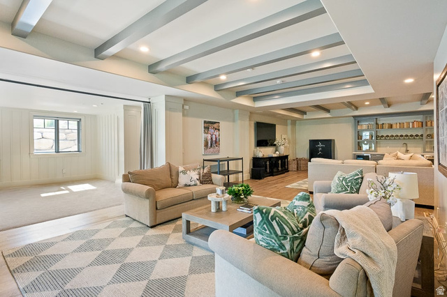 3 Carriagewood Cove, Unit 1088 Sandy, UT 84092 - Photo 54 of 79 Spacious lower-level living area featuring exposed ceiling beams, recessed lighting, wood-finish flooring, and a built-in wet bar with shelving