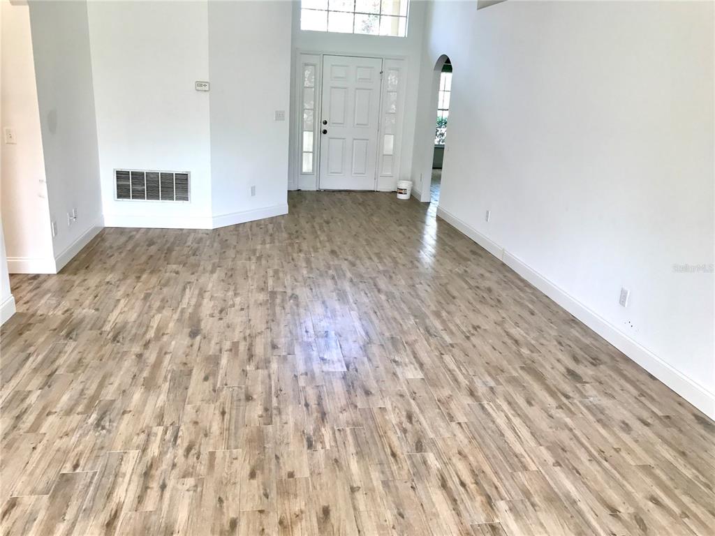 11156 Rouse Run Circle Orlando, FL 32817 - Photo 2 of 15 a view of empty room with wooden floor