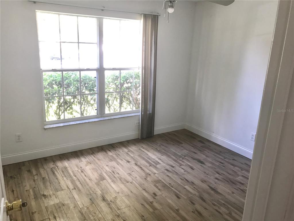 11156 Rouse Run Circle Orlando, FL 32817 - Photo 6 of 15 an empty room with wooden floor and windows