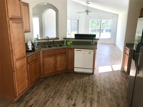 a kitchen with granite countertop a sink and a stove top oven