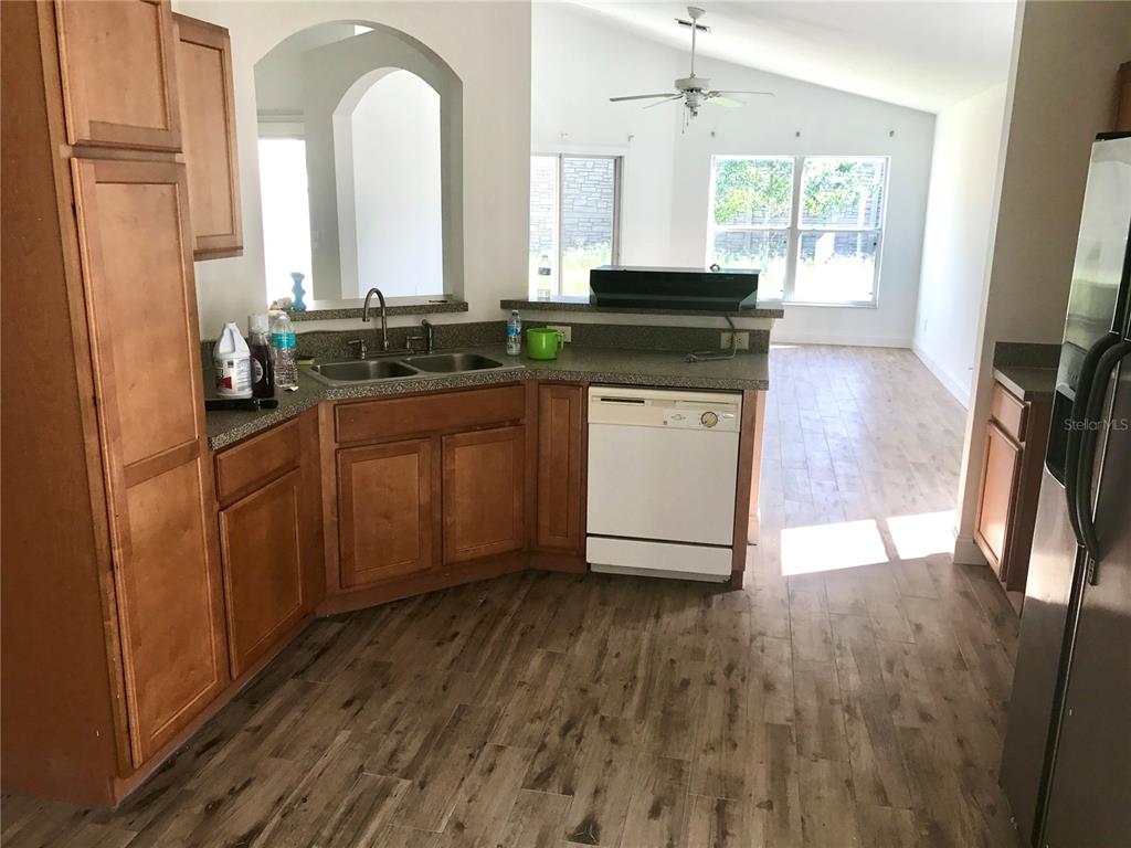 11156 Rouse Run Circle Orlando, FL 32817 - Photo 7 of 15 a kitchen with granite countertop a sink and a stove top oven