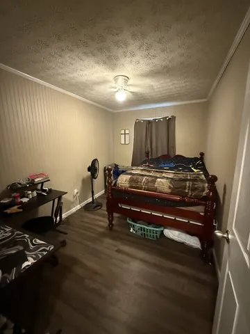 a bedroom with furniture and wooden floor