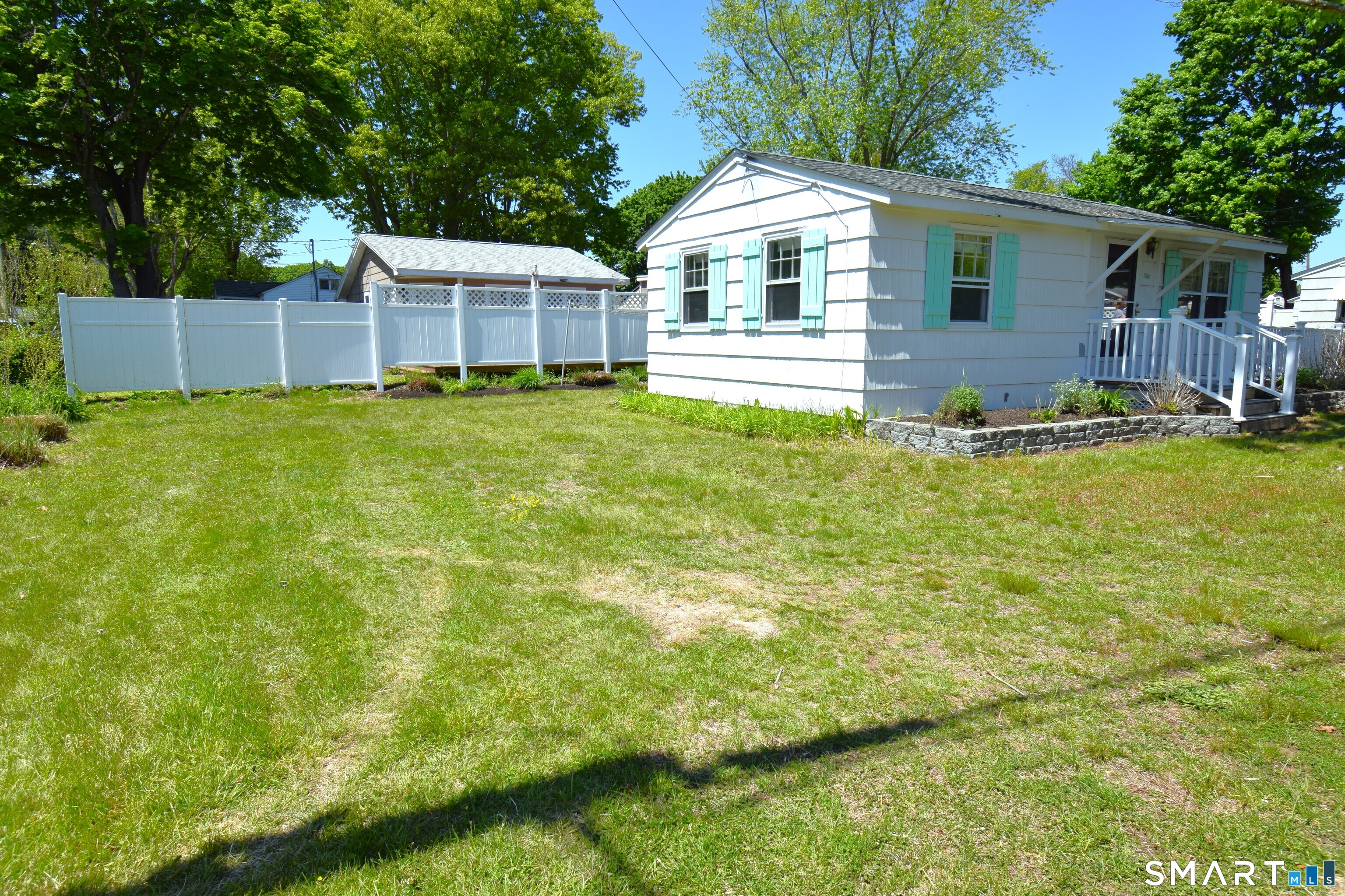 50 East Street Madison, CT 06443 - Photo 24 of 26 a front view of a house with a garden