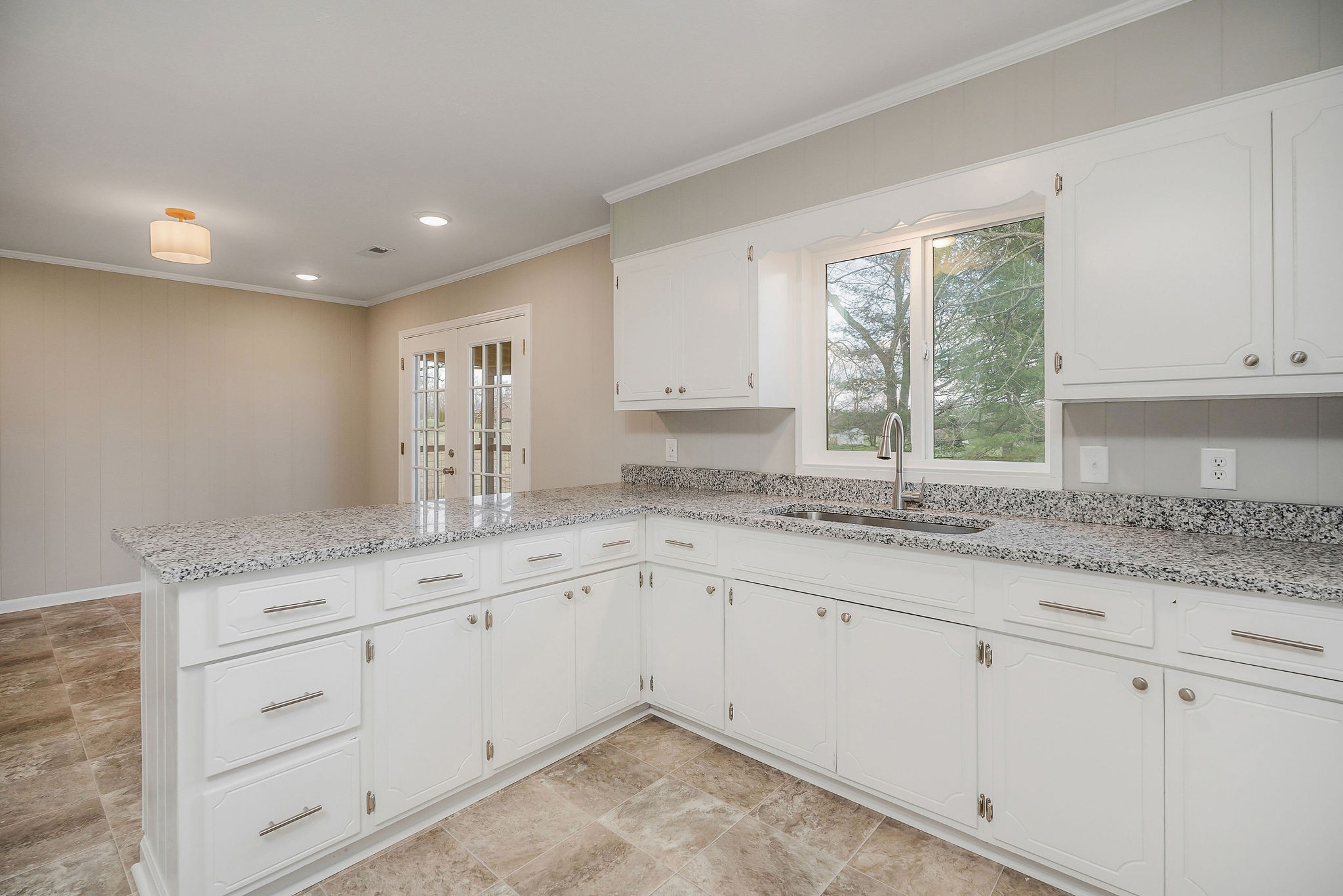 7159 Ditty Road Cookeville, TN 38506 - Photo 10 of 49 a kitchen with granite countertop white cabinets and a window