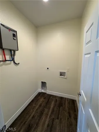 a view of small space with wooden floor and fan