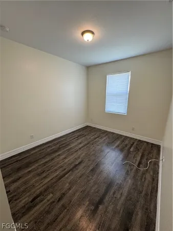 a view of room with wooden floor