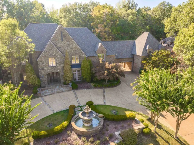 a view of a house with a yard and a sitting area