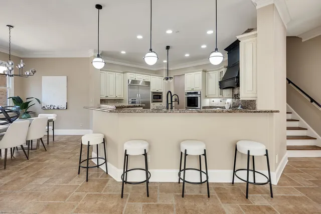 a large kitchen with a table and chairs