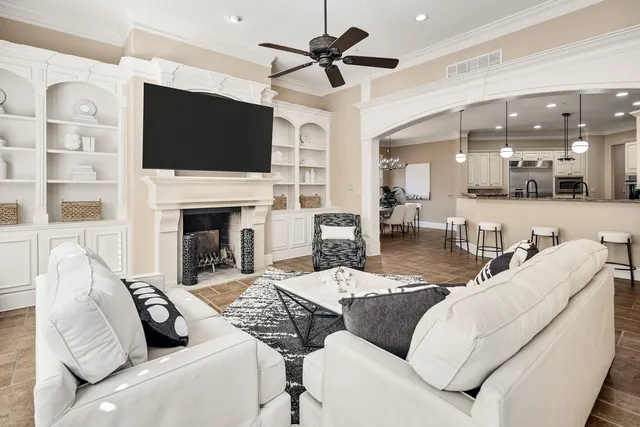 a living room with furniture a flat screen tv and a fireplace