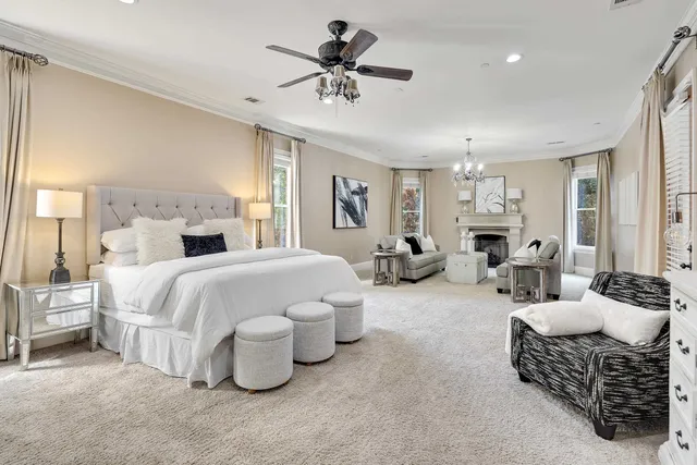a spacious bedroom with a bed and ceiling fan