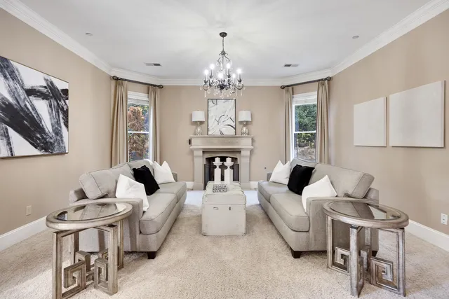 a living room with furniture chandelier and a window