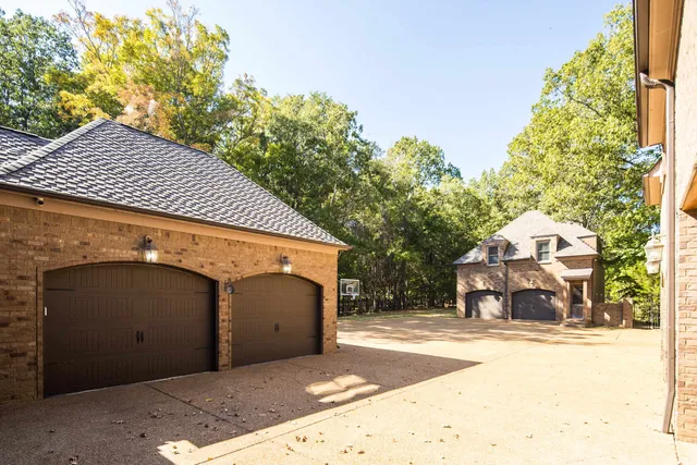 a view of a house with a yard and garage
