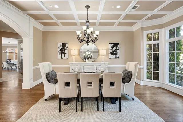 a view of a dining room with furniture wooden floor and chandelier