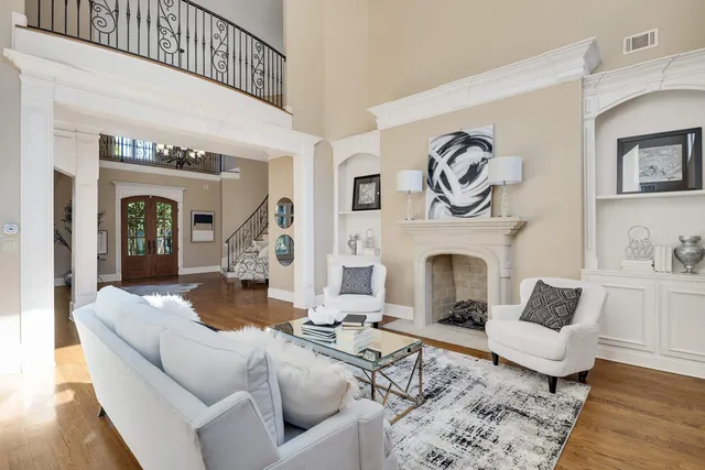 a living room with furniture and a fireplace with wooden floor