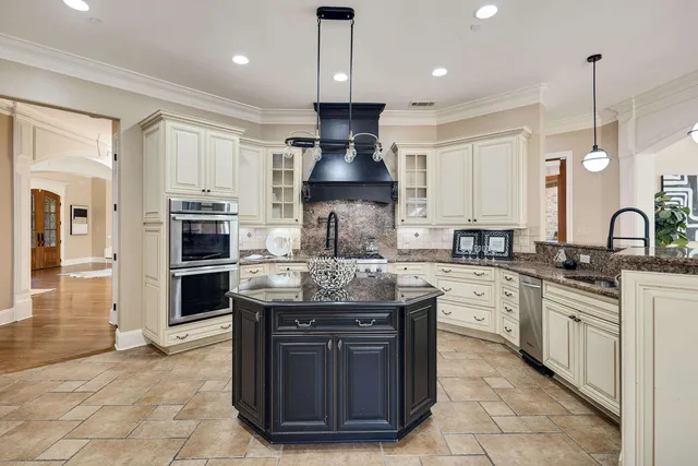 a kitchen with stainless steel appliances granite countertop a stove oven and a refrigerator