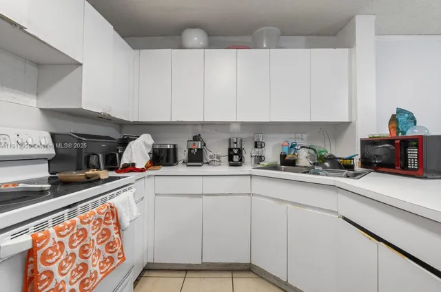 a kitchen with stainless steel appliances granite countertop a sink a stove and cabinets