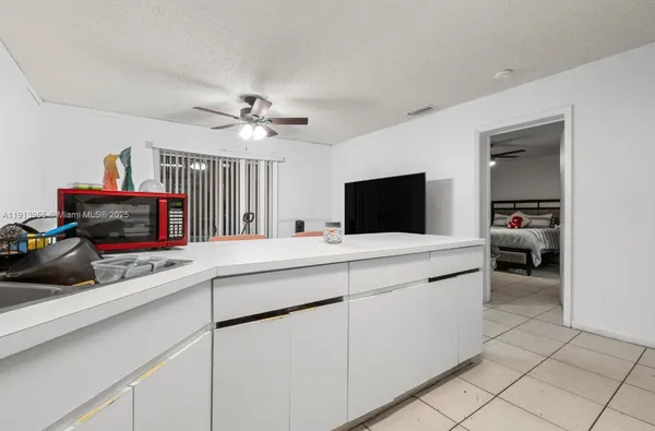a kitchen with a sink and a stove top oven
