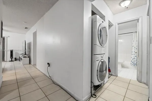 a view of a storage and utility room with washer and dryer