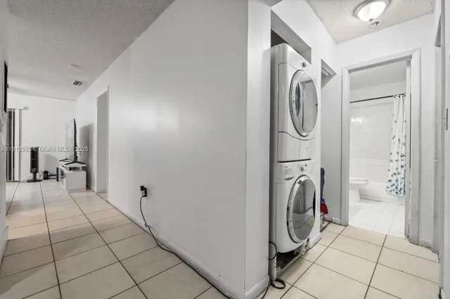 a view of a storage and utility room with washer and dryer