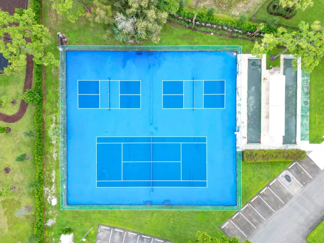 an aerial view of residential houses with outdoor space and street view